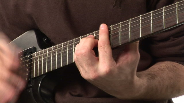 Man's hands playing a guitar