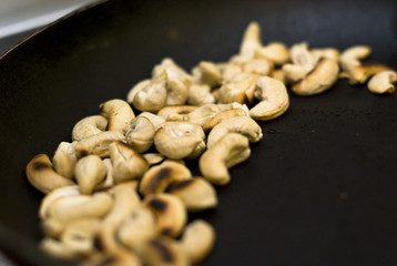 Toasted cashew nuts in a frying pan