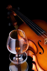 glass of cognac and violin