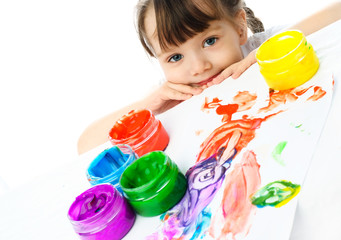 Fototapeta na wymiar cute girl painting with finger paints