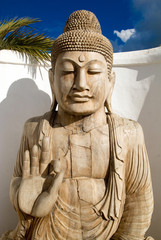 Buddah peaceful meditation under a blue sky