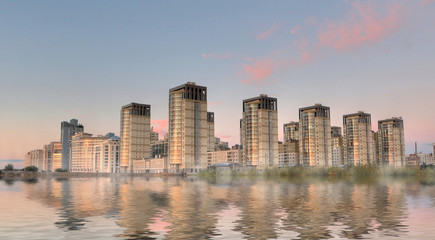 Group of buildings near water with mist