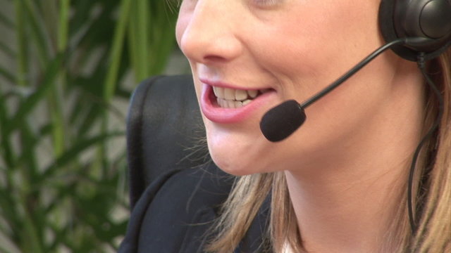 Businesswoman working with headset in a office