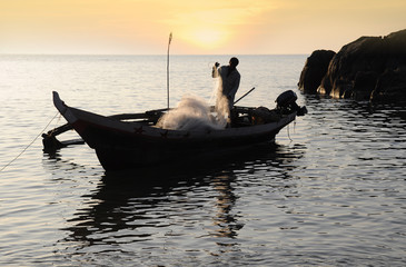 Fisherman with nets on his boat