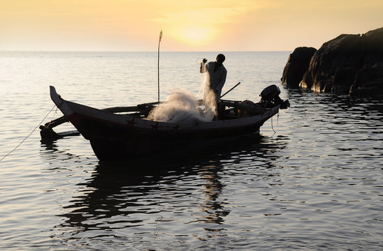 Fisherman with nets on his boat - Powered by Adobe