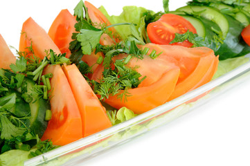 Tomatoes and cucumbers in a glass dish