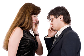 Young couple talking on the phone isolated on white