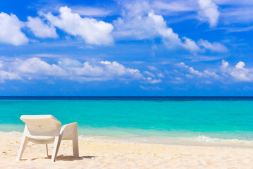 Fototapeta na wymiar Chair on tropical beach