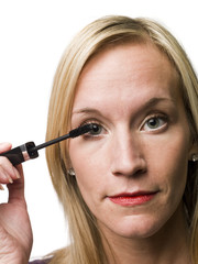 Woman poting on mascara