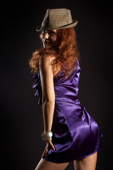 sexual woman in a hat on a black background