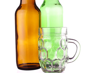 Tankard and bottles of beer on white background