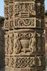 Carving of intricate design in stone pillar