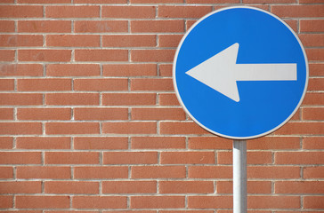 One way heading to left on wall background