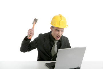 Amgry businessman and hammer with computer