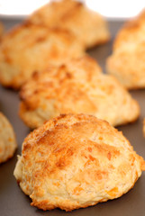 Cheddar cheese biscuits on a cookie sheet