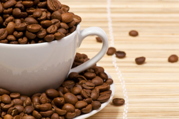 Macro studio shot of a cup of coffee beans.