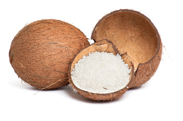 Whole and broken coconut on a white.