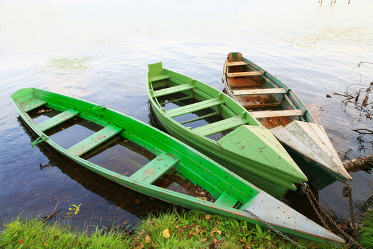 three wooden boats