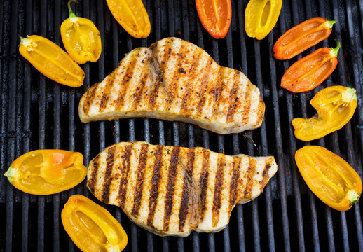 Swordfish Steaks Cook On The Bar-b-que Grill With Bell Peppers