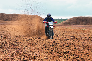 Offroad motorbike driving in dirt.