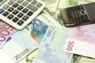 Dollar, euro banknotes, calculator and cellphone
