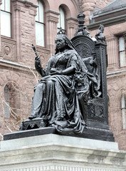Statue of Queen Victoria seated on throne