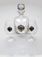 Composition of two wineglasses and carafe on white background