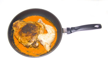 frying chicken on pan with sauce