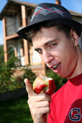 Young happy man with apple beside him new house