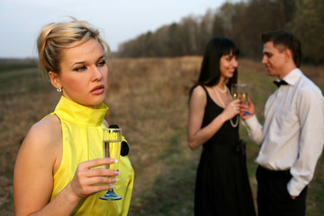 jealousy - two girl and man with wine outdoors