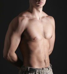 Fototapeta premium Young Sporty Man over Black Background, Body Parts