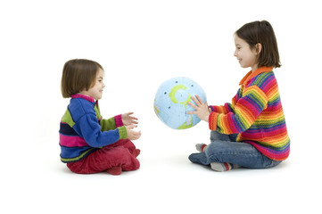 two children embracing the world globe isolated on white