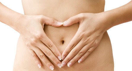 Love - A woman's hands forming a heart symbol on belly