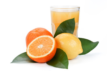 Fruits with green leaves and glass of juice