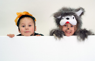 Funny kids above big blank sheet of paper