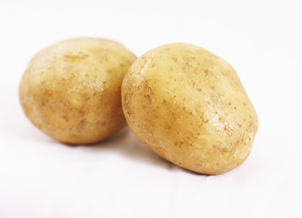 Close up of Two Potatoes on White Background