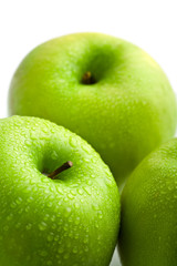 fresh green apples with water droplets isolated