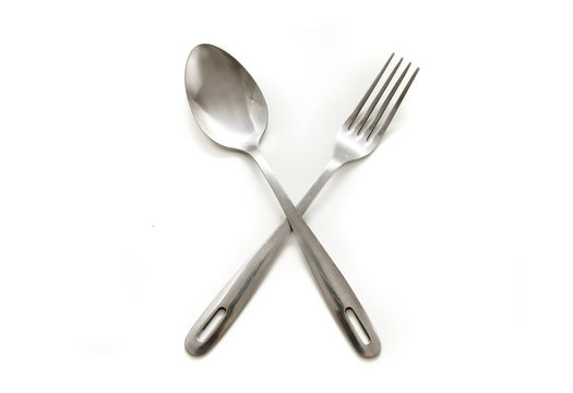 concept shot of spoon and fork over white
