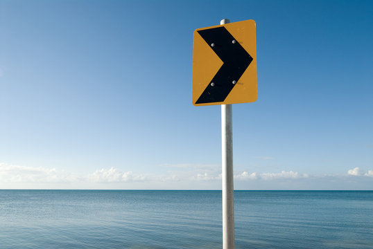 Yellow traffic sign at sea