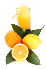 Fruits with green leaves and glass of juice