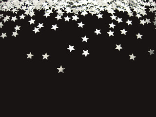 Silver stars confetti on black background