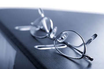 binder and glasses toned blue isolated