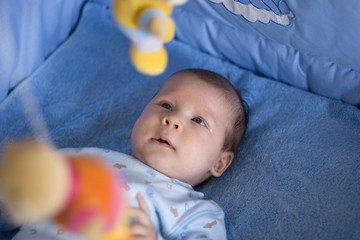 Cute happy baby in bed