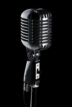 Retro microphone on stand isolated on black