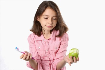 Fototapeta premium Young Girl With Toothbrush And Apple