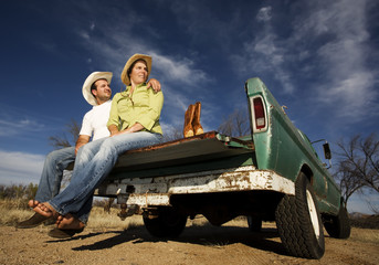 Cowboy and woman on pickup truck