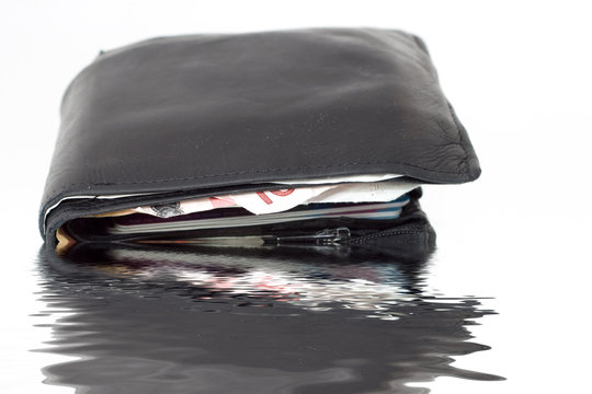 Old Leather Wallet with Money drowning in water