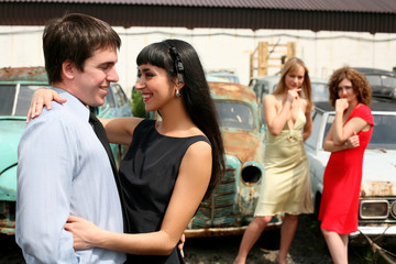 jealousy - couple and two girl beside vintage car