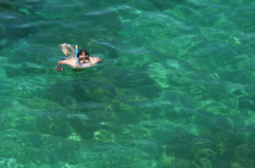 Obraz na płótnie Canvas Surfacing Snorkeler