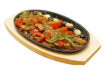 Roastpig with vegetables on carving board